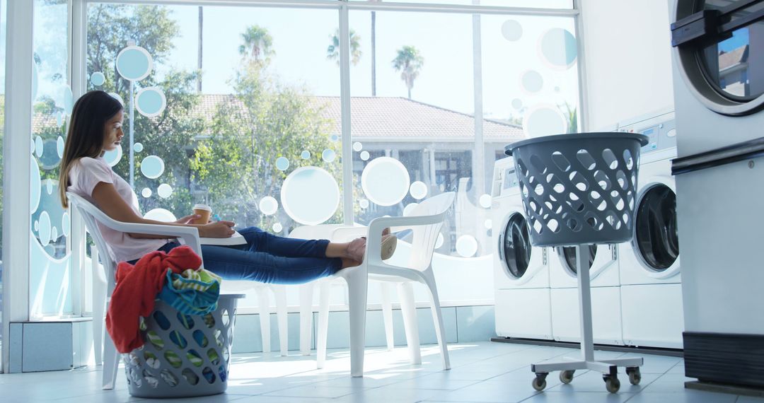 Woman Relaxing in Laundromat with Laundry Baskets - Free Images, Stock Photos and Pictures on Pikwizard.com