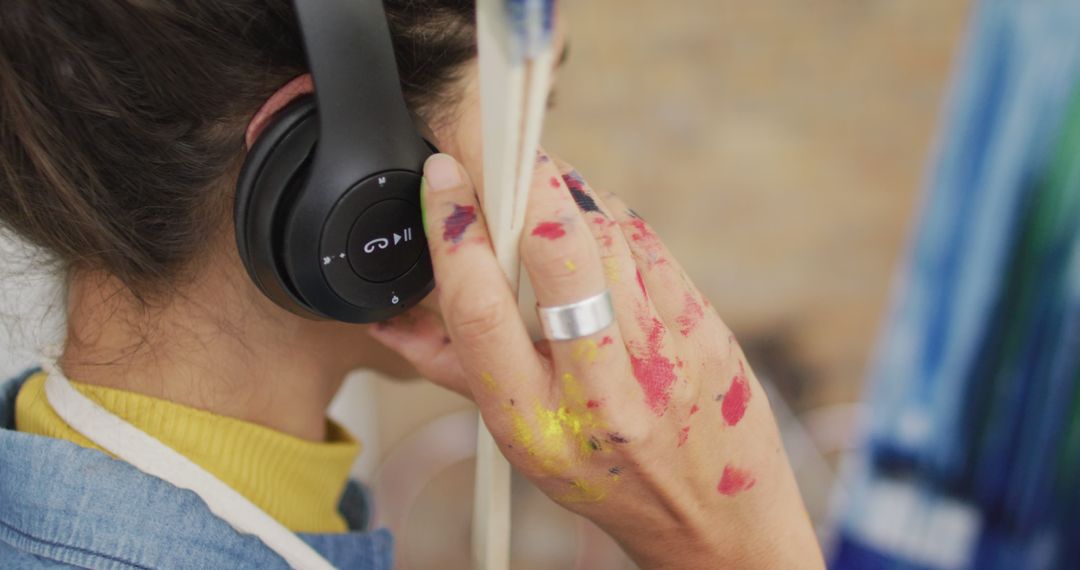 Artist with Paint-Stained Hands Listening to Music - Free Images, Stock Photos and Pictures on Pikwizard.com