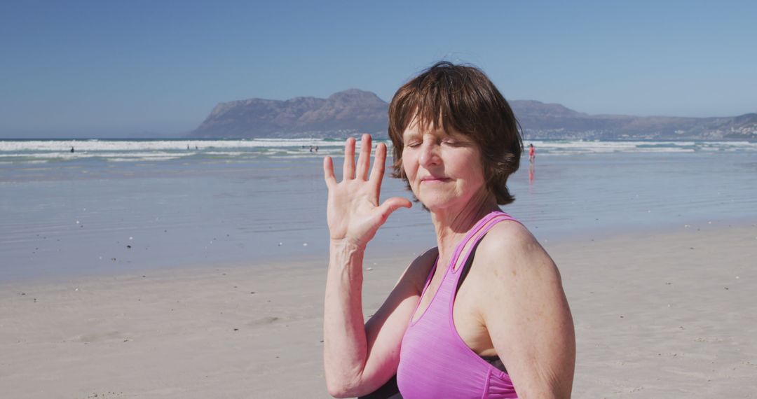 Portrait of caucasian senior woman waving on sunny beach - Free Images, Stock Photos and Pictures on Pikwizard.com