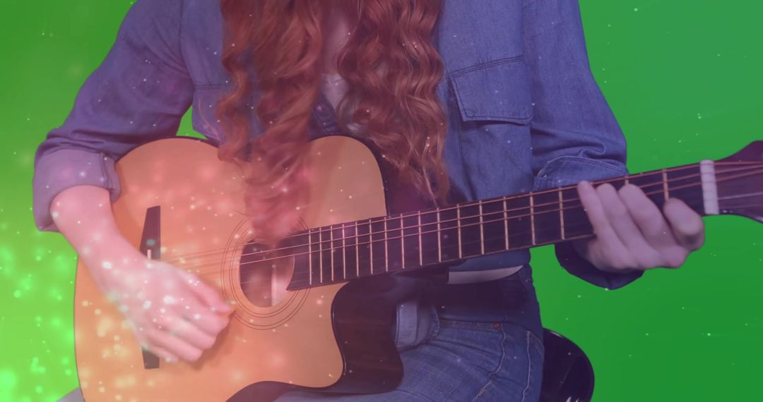 Female musician playing acoustic guitar with vibrant overlay