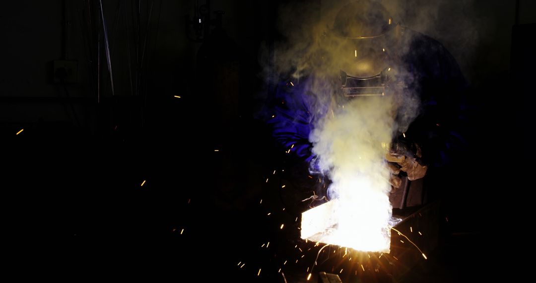 Industrial Worker Welding Metal with Sparks and Smoke - Free Images, Stock Photos and Pictures on Pikwizard.com