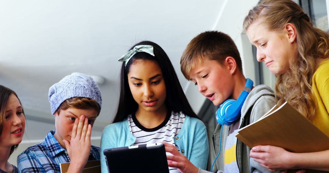 Diverse Group of Students Engaged with Tablet in School