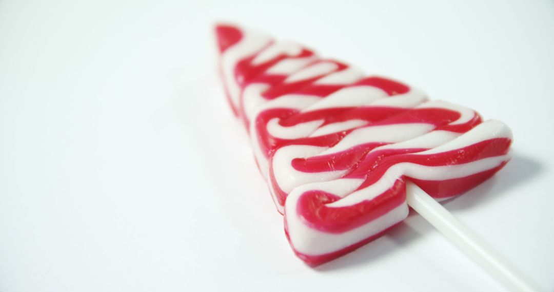 Red and White Swirled Triangle Lollipop on White Background - Free Images, Stock Photos and Pictures on Pikwizard.com