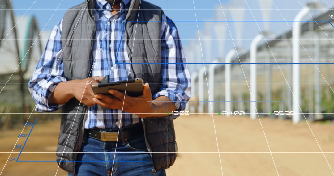 Engineer Analyzing Data on Tablet in Agricultural Setting