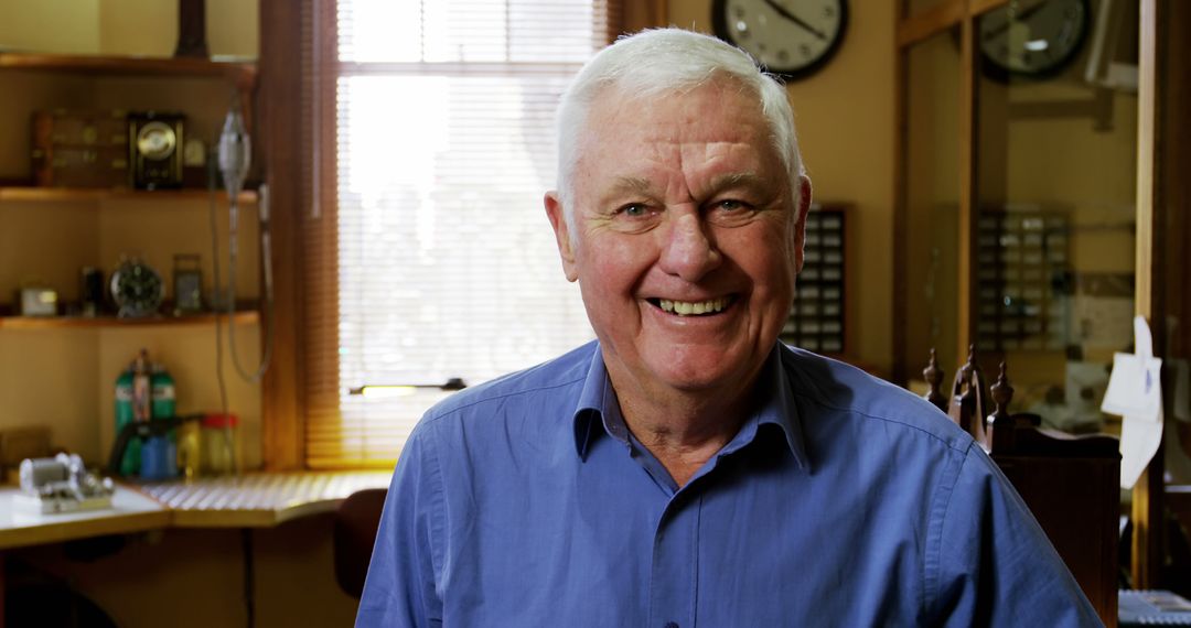 Smiling Senior Man in Blue Shirt in Home Office - Free Images, Stock Photos and Pictures on Pikwizard.com