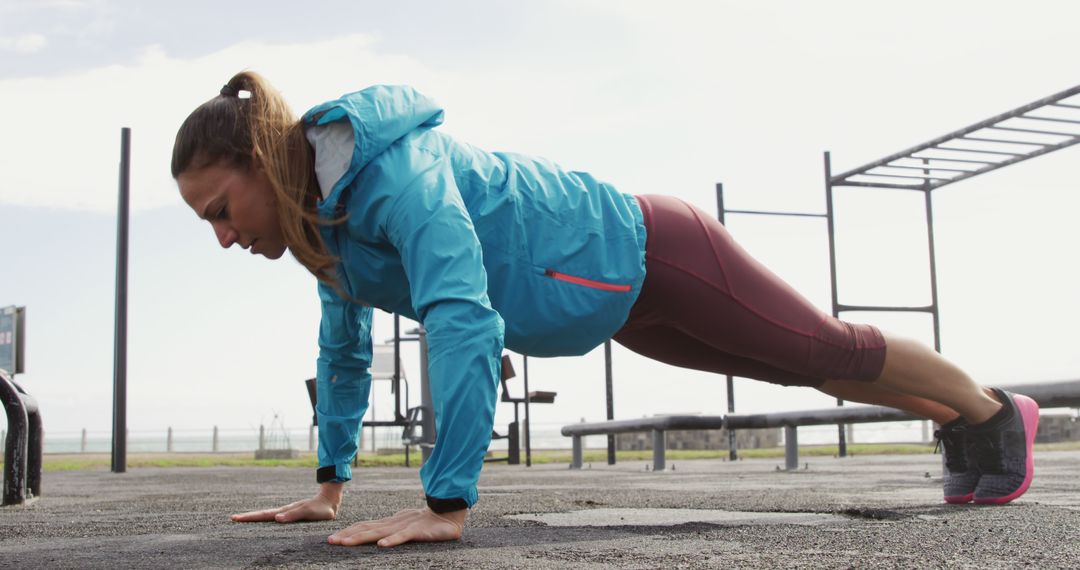 Determined Woman in Sportswear Doing Outdoor Pushups - Free Images, Stock Photos and Pictures on Pikwizard.com