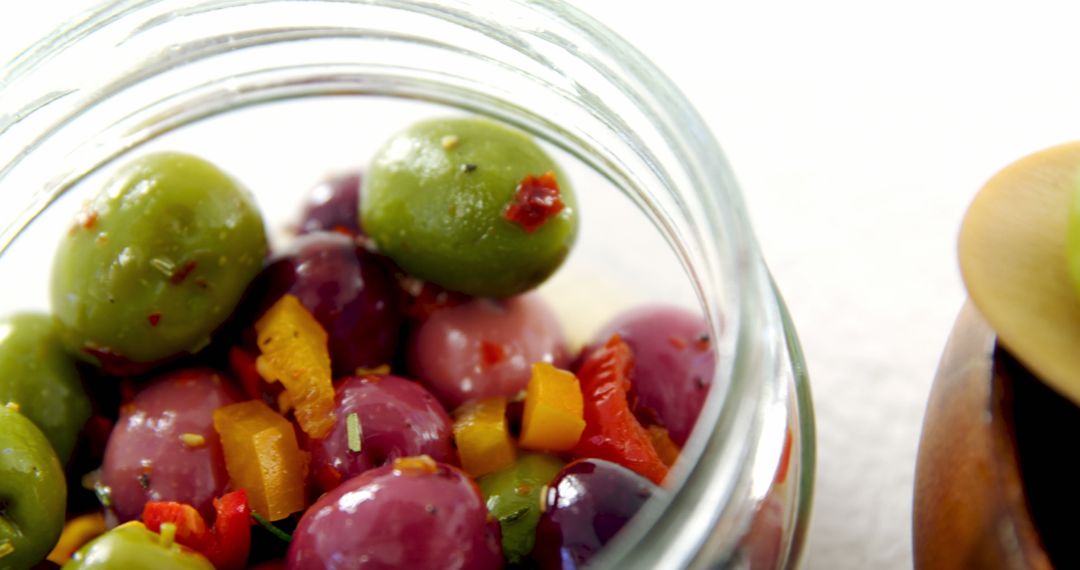 Colorful Marinated Olives in Glass Jar with Herbs and Peppers - Free Images, Stock Photos and Pictures on Pikwizard.com