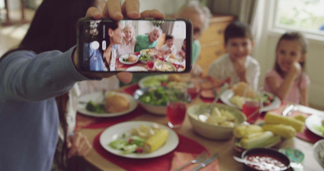 Family Taking Selfie During Gathered Meal Around Table - Free Images, Stock Photos and Pictures on Pikwizard.com