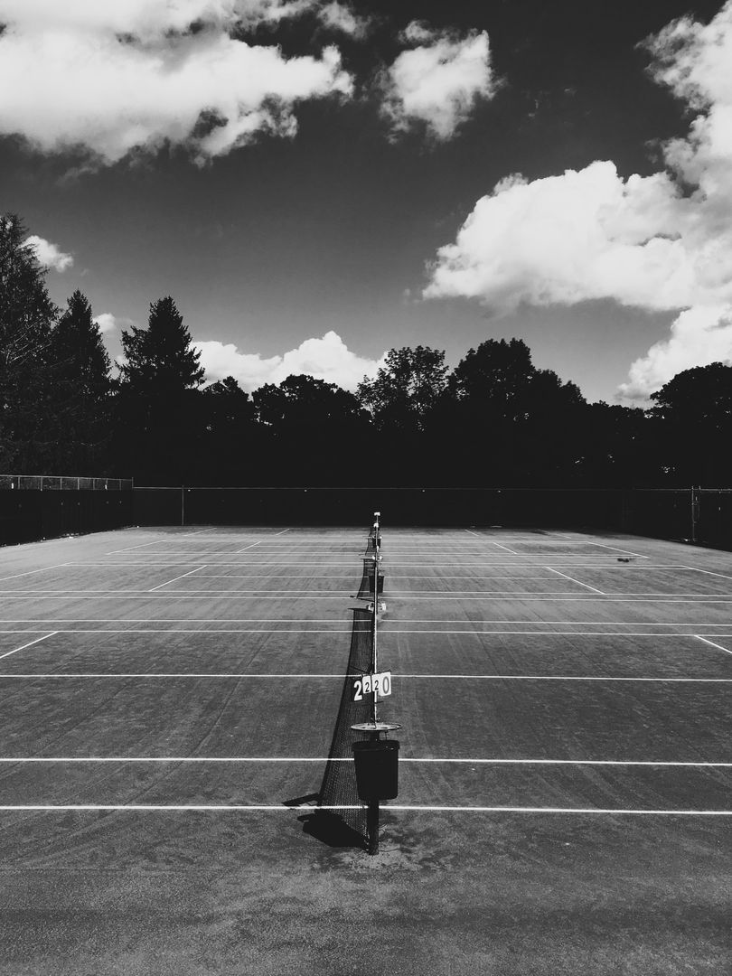 Empty Tennis Court on Cloudy Day in Black and White - Free Images, Stock Photos and Pictures on Pikwizard.com