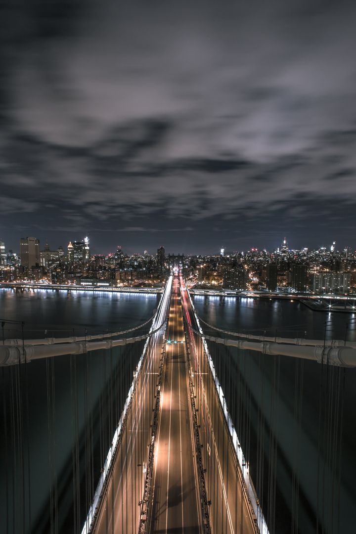 Night View of Suspension Bridge with City Skyline and Traffic - Free Images, Stock Photos and Pictures on Pikwizard.com