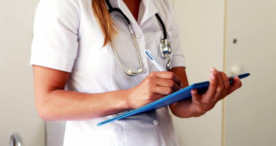 Female Doctor Writing Patient Notes in Hospital Ward - Free Images, Stock Photos and Pictures on Pikwizard.com