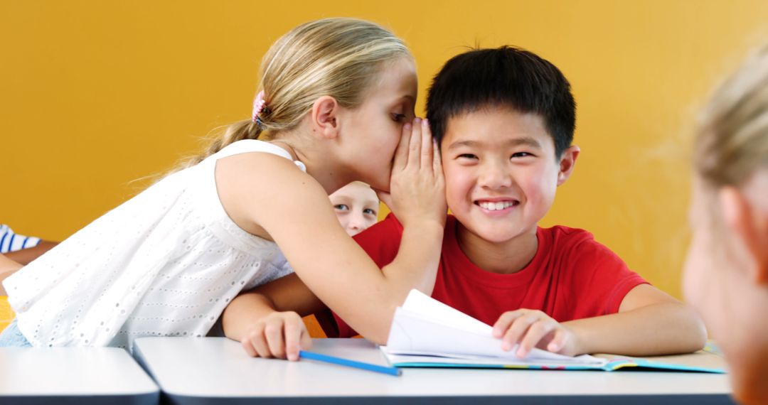 Children Whispering and Smiling in Classroom - Free Images, Stock Photos and Pictures on Pikwizard.com