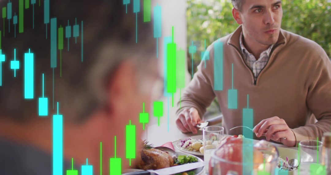 Man Cutting Dinner at Home Table with Green Blue Stock Market Candlestick Chart Overlay