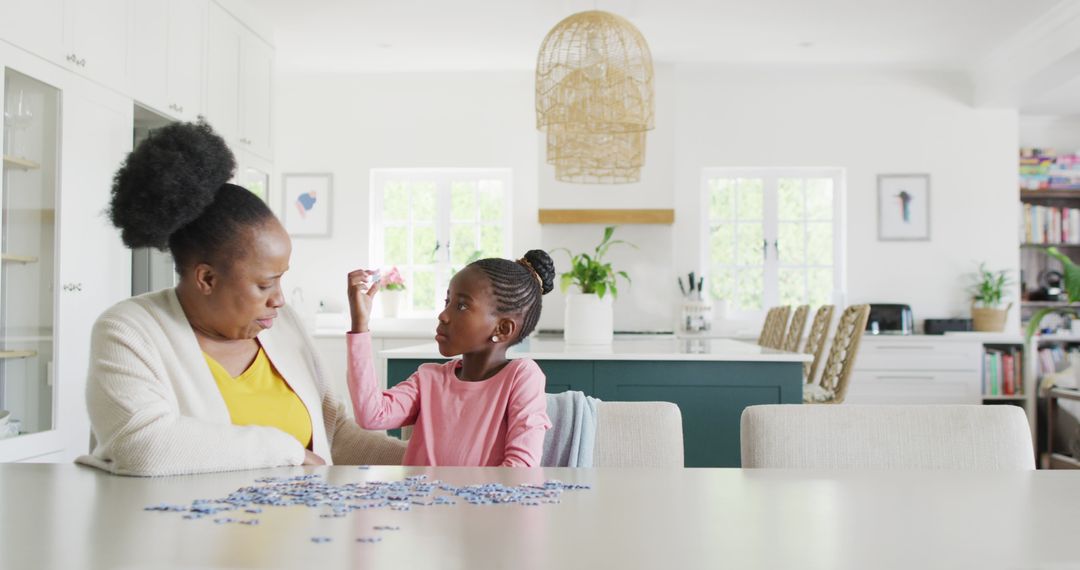 Happy african american granddaughter and grandmother doing jigsaw puzzle at home, copy space - Free Images, Stock Photos and Pictures on Pikwizard.com