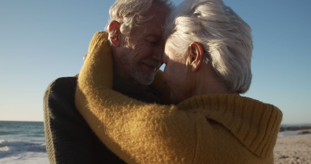 Senior Couple Embracing on Beach During Sunset - Free Images, Stock Photos and Pictures on Pikwizard.com