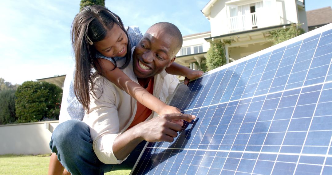 Father and Daughter Exploring Solar Panel for Sustainable Energy Education