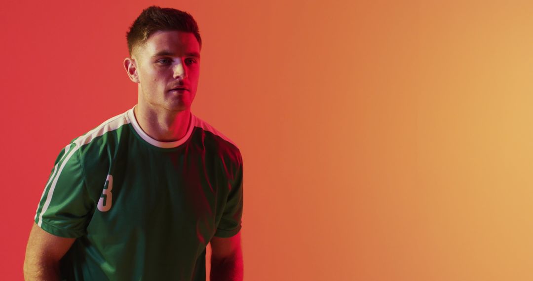 Focused Soccer Player in Action Against Vibrant Background