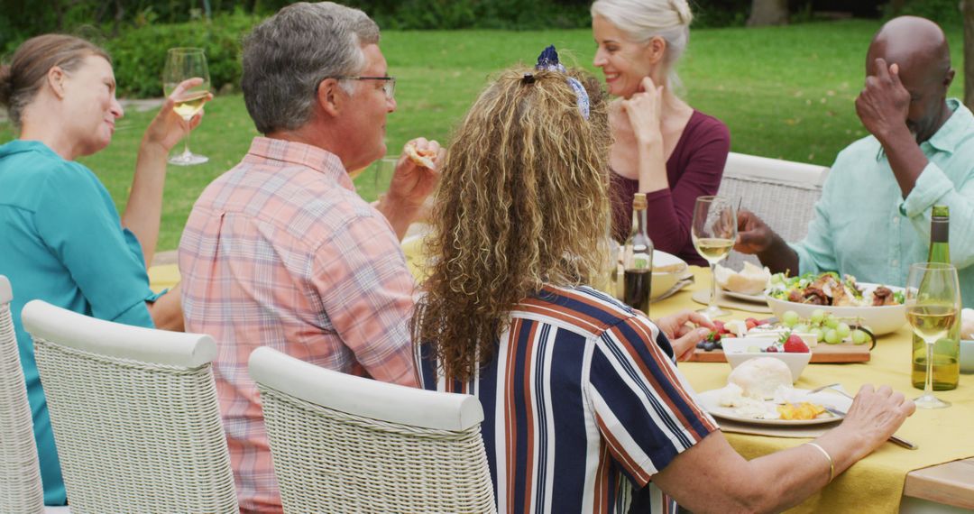 Group of Diverse Adults Enjoying Outdoor Meal Together - Free Images, Stock Photos and Pictures on Pikwizard.com