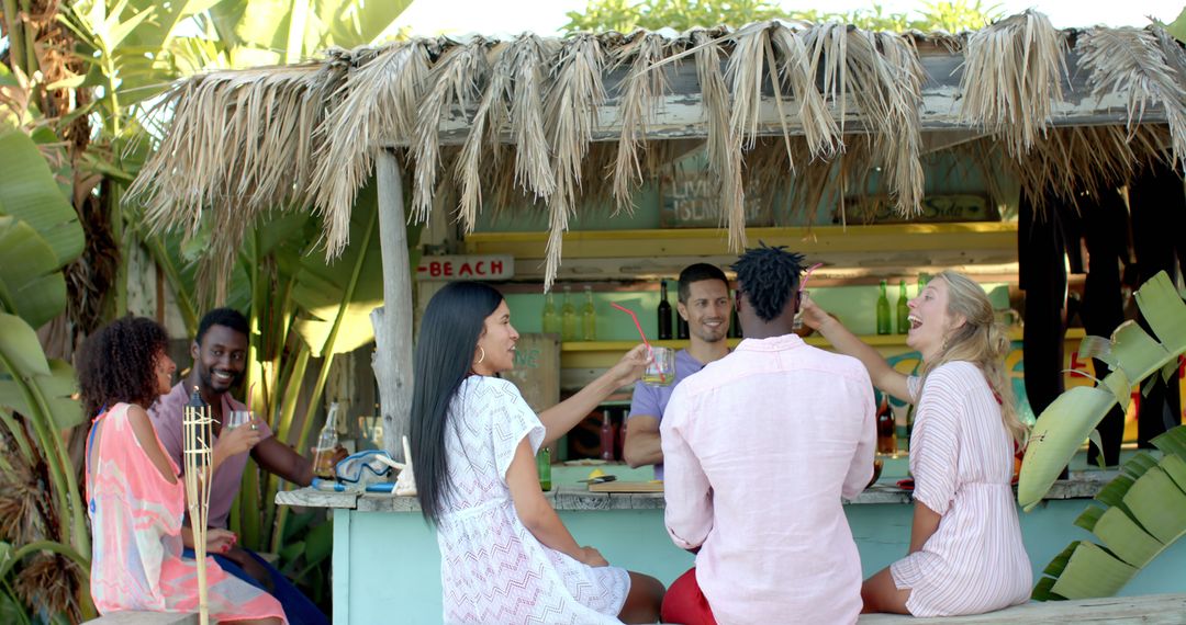 Group of Friends Enjoying Refreshments at a Tropical Beach Bar - Free Images, Stock Photos and Pictures on Pikwizard.com