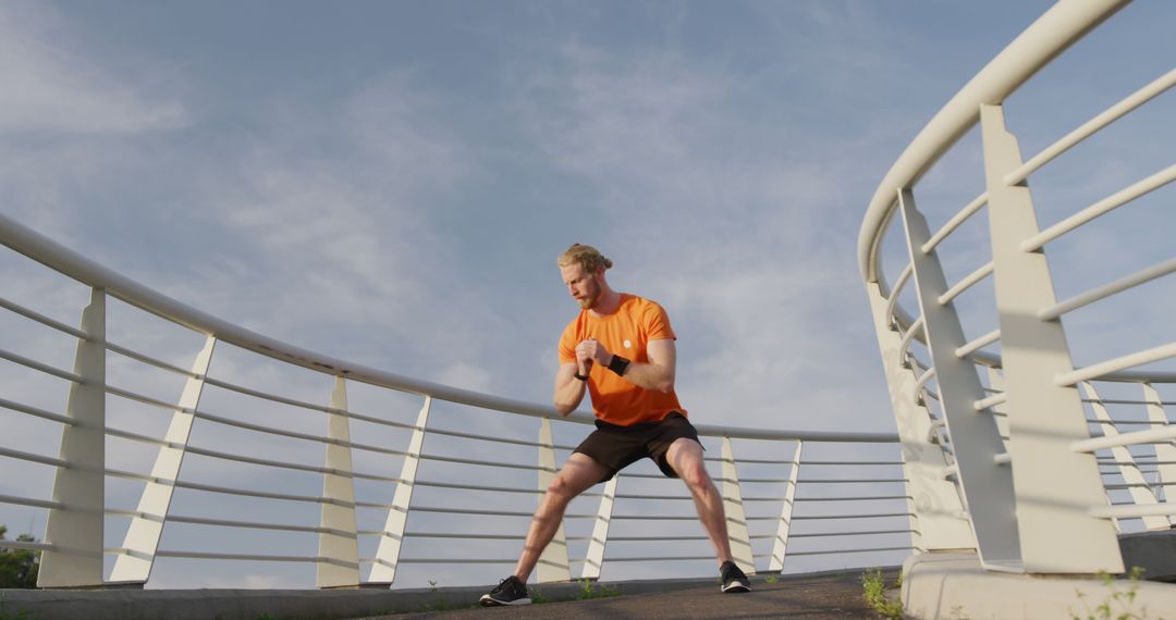 Active Man Stretching on Modern City Bridge