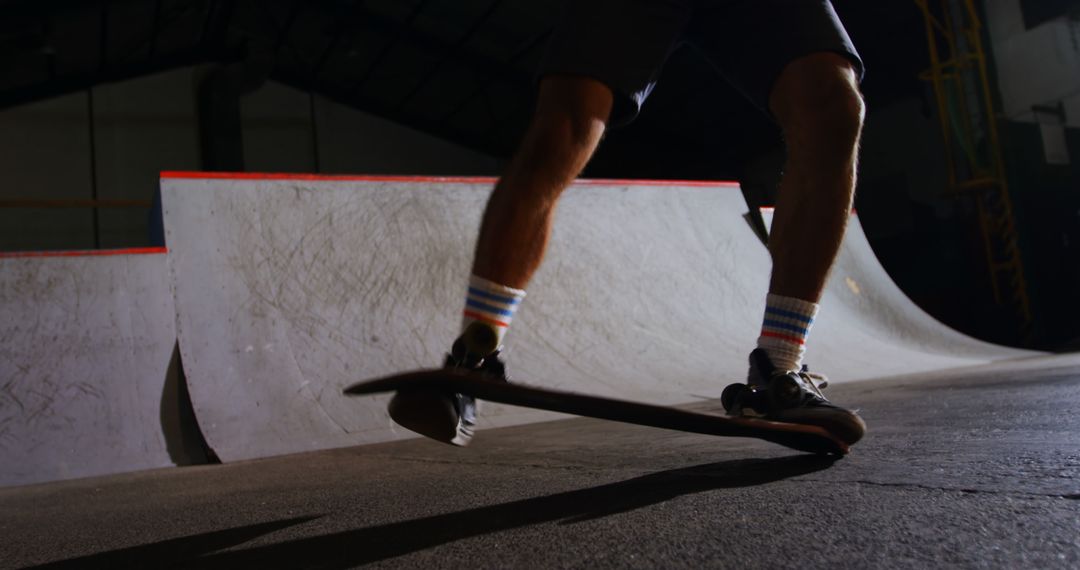 Skateboarder Performing Trick in Indoor Skate Park - Free Images, Stock Photos and Pictures on Pikwizard.com