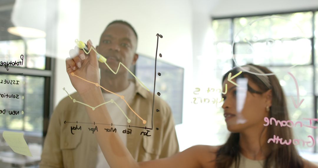 Diverse Team Analyzing Business Growth Trends on Glass Board