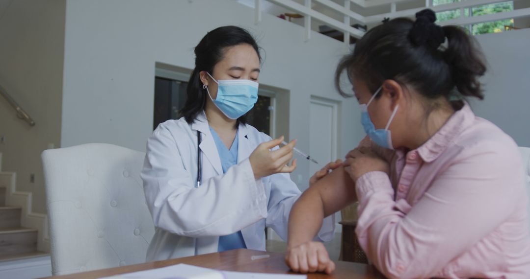 Doctor Administering Vaccine to Patient in Medical Office - Free Images, Stock Photos and Pictures on Pikwizard.com