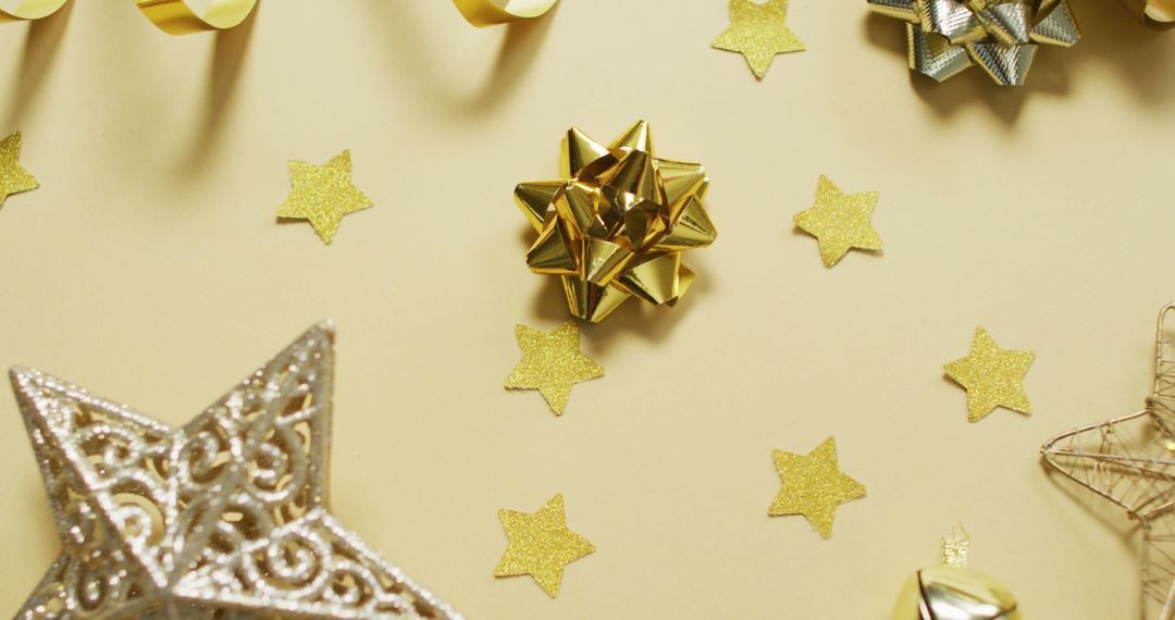 Image of gold christmas decorations with stars on yellow background - Free Images, Stock Photos and Pictures on Pikwizard.com