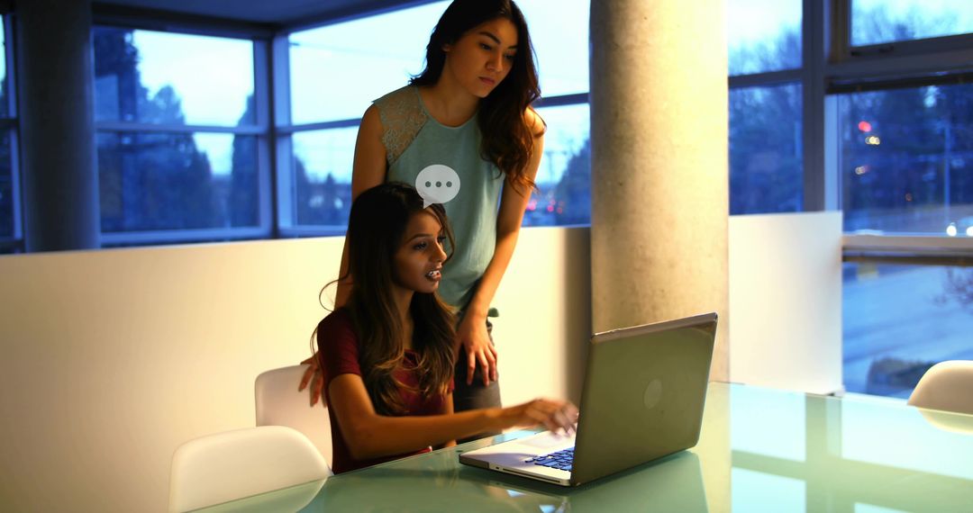 Colleagues Working Together on Laptop in Modern Office Setting