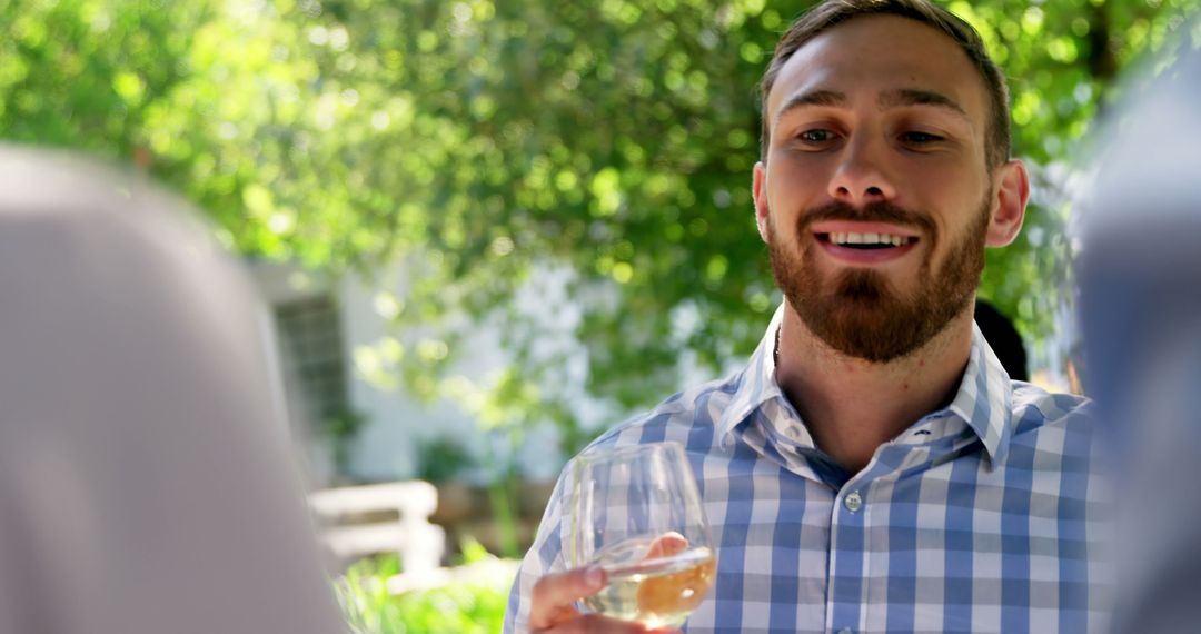 Man Enjoying Outdoor Social Event with Drink - Free Images, Stock Photos and Pictures on Pikwizard.com