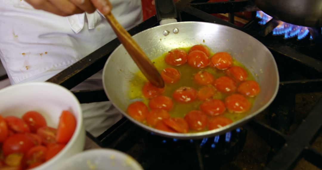 Chef Stirring Cherry Tomatoes in Pan on Stove - Free Images, Stock Photos and Pictures on Pikwizard.com