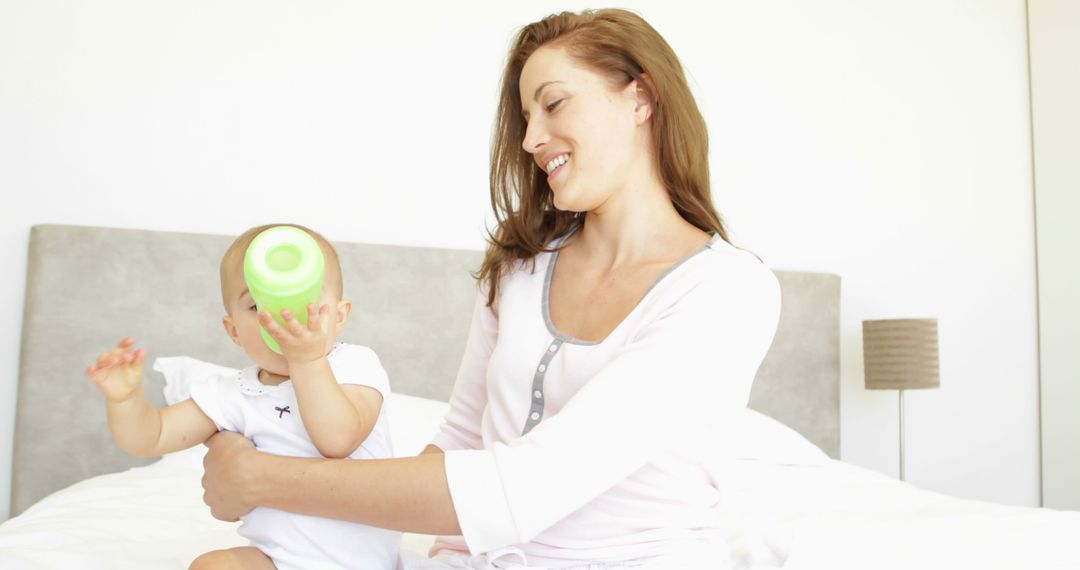 Mother Drinking Coffee While Holding Baby - Free Images, Stock Photos and Pictures on Pikwizard.com