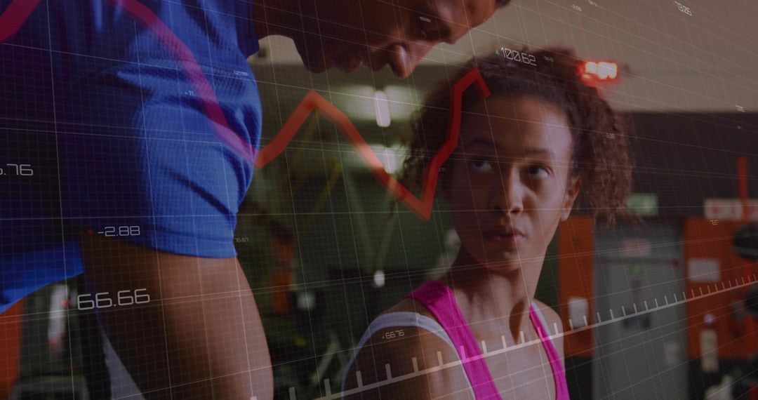 Trainer Guiding Client in Gym with Performance Analytics Data