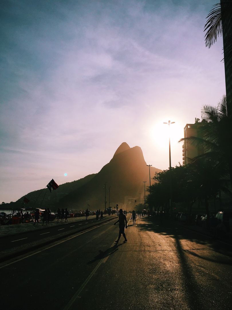 People Enjoying Sunset at Ipanema Beach with Mountains in Background - Free Images, Stock Photos and Pictures on Pikwizard.com