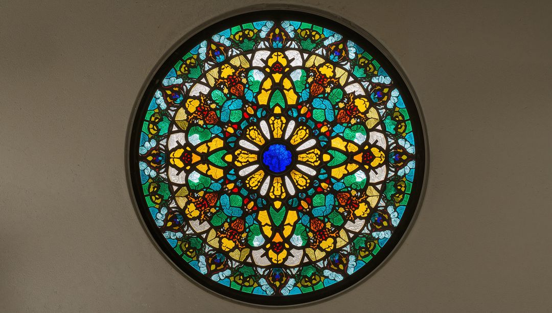 Intricate Circular Stained Glass Window with Floral Geometric Design