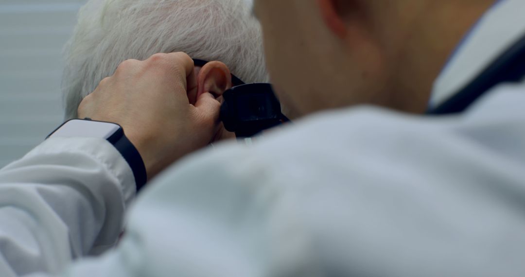 Doctor examining patient ear with otoscope in clinic - Free Images, Stock Photos and Pictures on Pikwizard.com