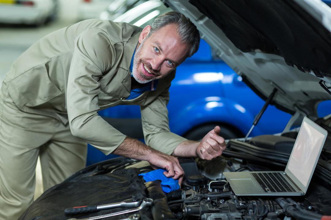 Mechanic servicing a car engine in auto repair garage - Free Images, Stock Photos and Pictures on Pikwizard.com