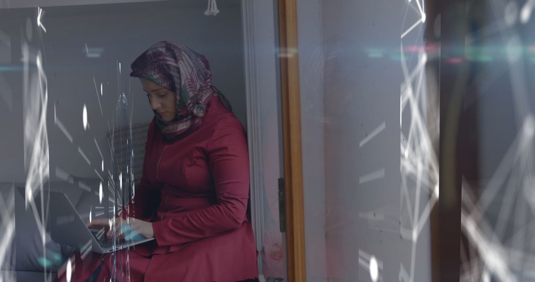 Woman in Hijab Using Laptop with Digital Interface Concept