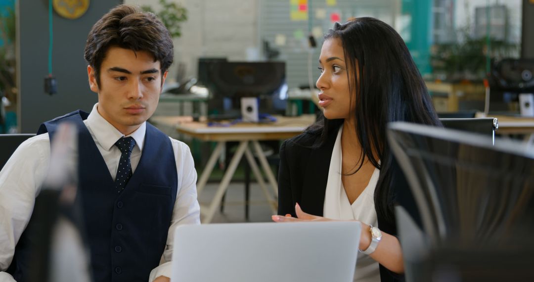 Diverse Coworkers Collaborating on Project in Modern Office