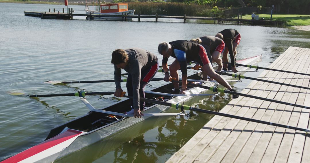 Team of Diverse Rowers Preparing Canoe on Lake - Free Images, Stock Photos and Pictures on Pikwizard.com