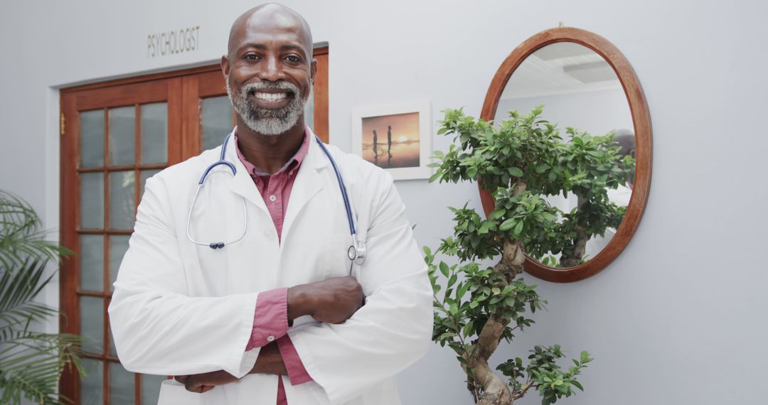 Confident African American Doctor Standing with Arms Crossed in Office - Free Images, Stock Photos and Pictures on Pikwizard.com