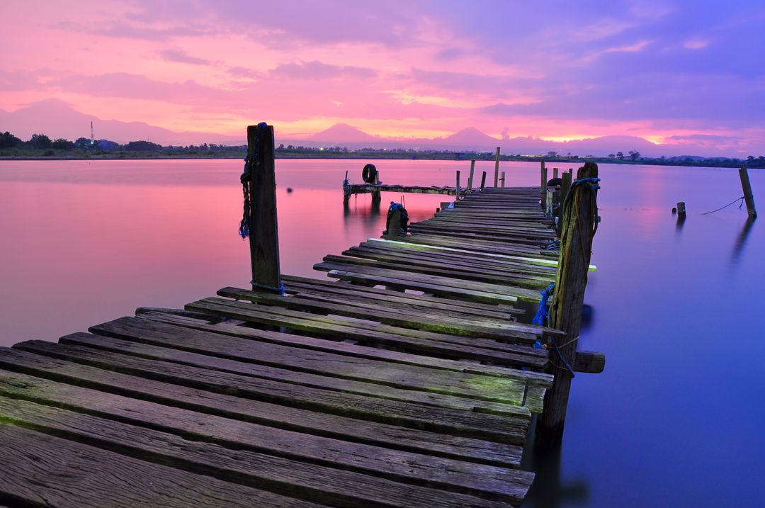 Serene Old Wooden Pier at Twilight with Vibrant Sunset Sky - Free Images, Stock Photos and Pictures on Pikwizard.com