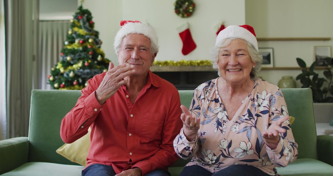 Senior Couple Enjoying Christmas at Home Wearing Santa Hats - Free Images, Stock Photos and Pictures on Pikwizard.com