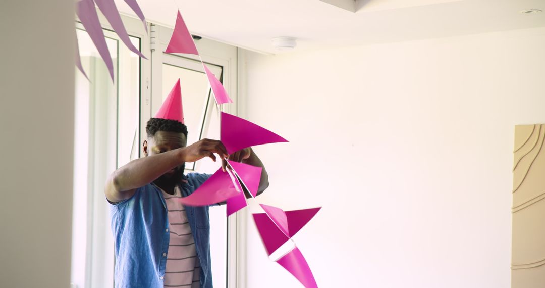 Man Setting Up Pink Bunting for Celebration