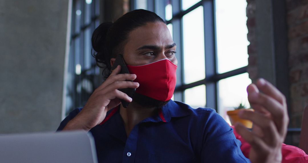 Remote Work During Pandemic: Man Using Smartphone and Laptop in Cafe
