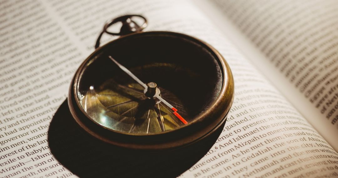 Vintage Compass Resting on Open Bible Reflecting Faith and Guidance