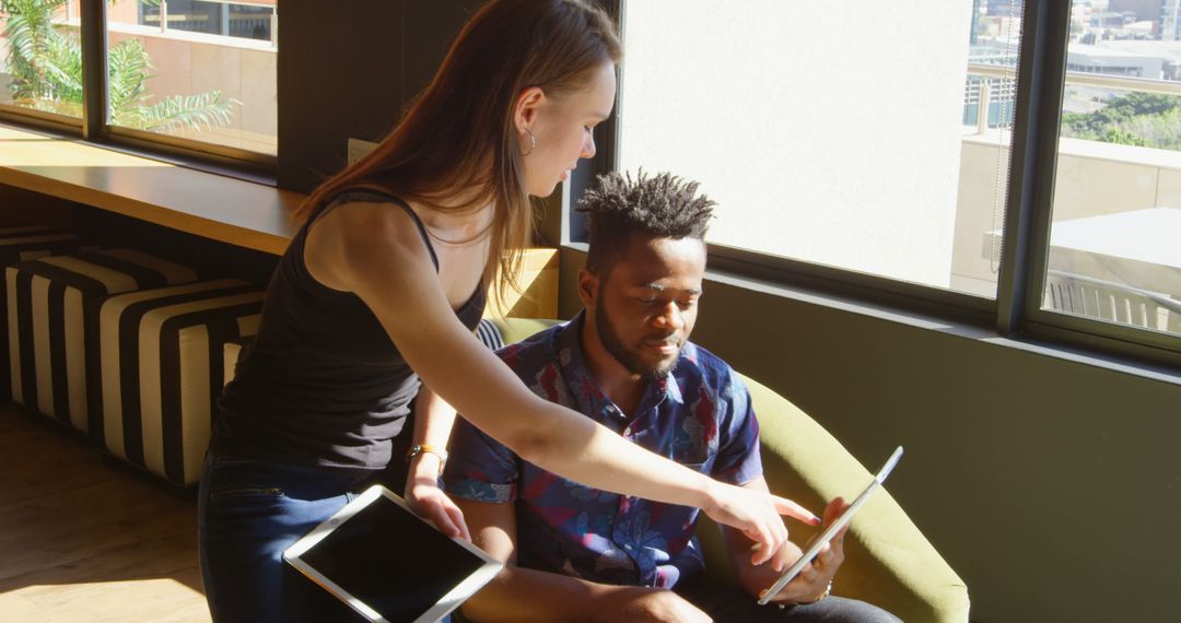 Diverse Team Collaborating with Digital Tablet in Bright Office
