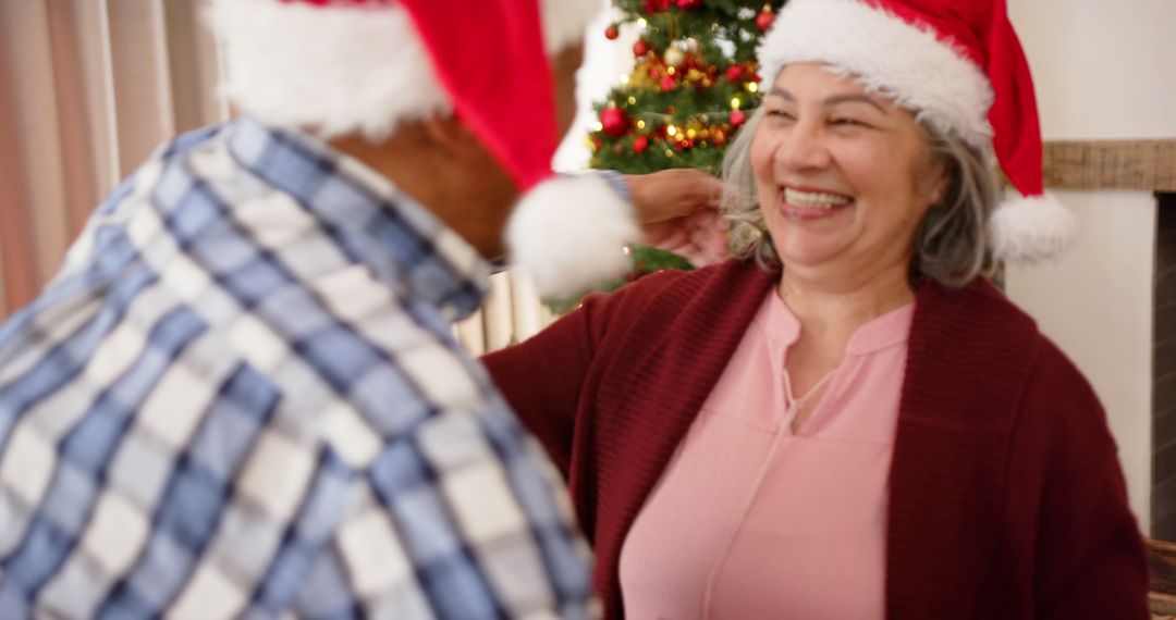 Happy Seniors Celebrating Christmas with Santa Hats - Free Images, Stock Photos and Pictures on Pikwizard.com