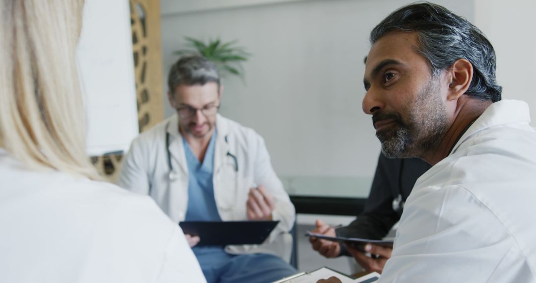 Medical Professionals Discussing Patient Case During Meeting - Free Images, Stock Photos and Pictures on Pikwizard.com