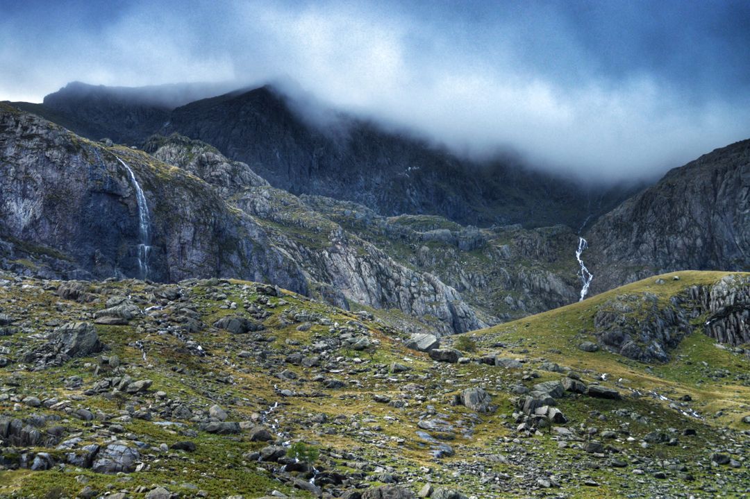 Majestic Mountain Range with Waterfalls and Low Clouds - Free Images, Stock Photos and Pictures on Pikwizard.com